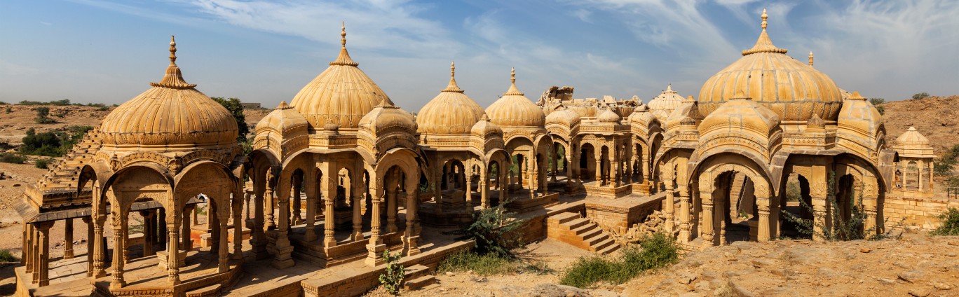 Few brown colour buildings with tombs